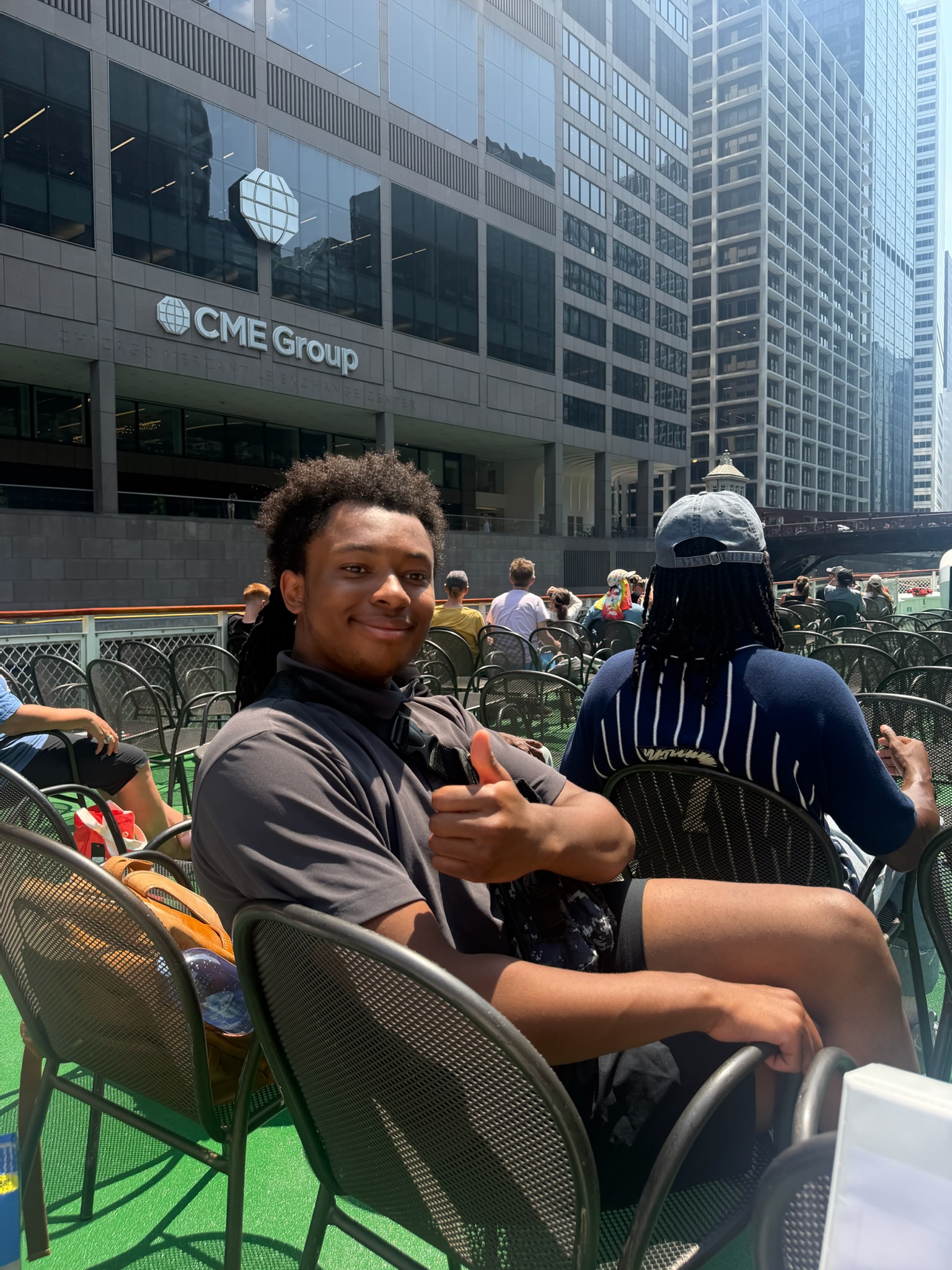 A student gives a thumbs up aboard the First Lady boat tour on the Chicago River