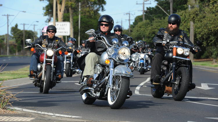 Group of motorcyclists riding together on a road