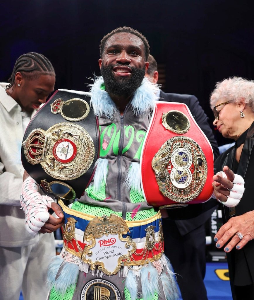 Jaron Ennis draped in championship belts