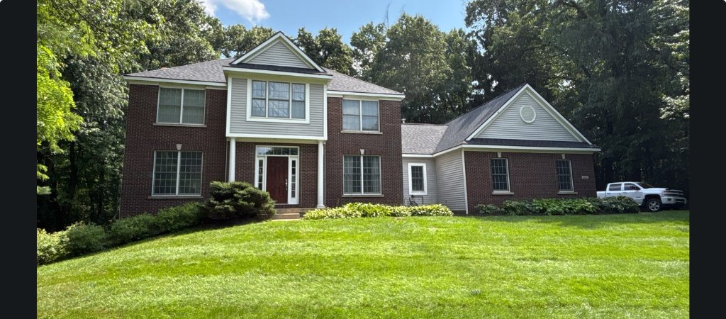Completed roof replacement viewed from the front in Alto, MI
