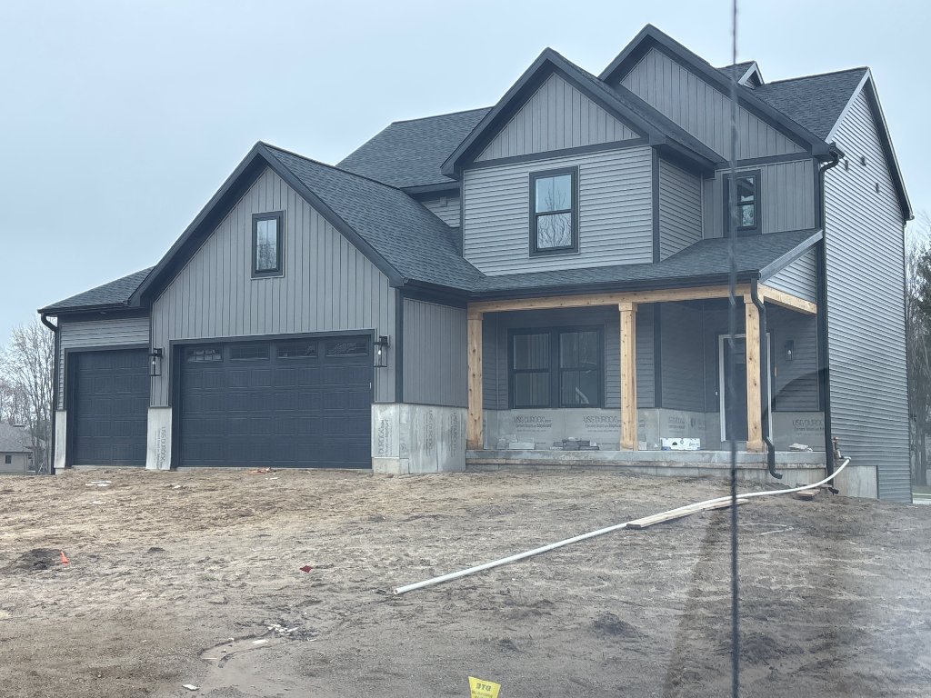 Completed front elevation of a new-construction home sided by Grandville Roofing & Exteriors in Byron Center, MI