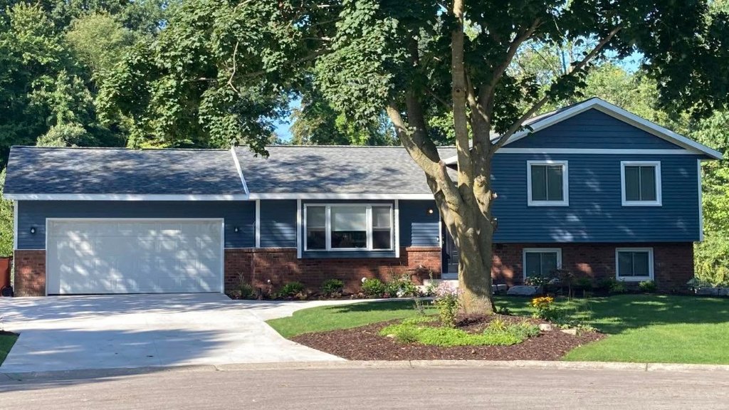 Completed new siding, front elevation, on a home in Lake Bella Vista, MI