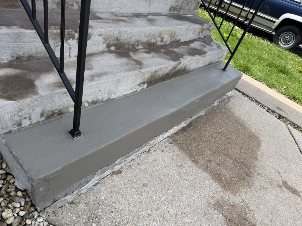Finished concrete patch repair on exterior steps