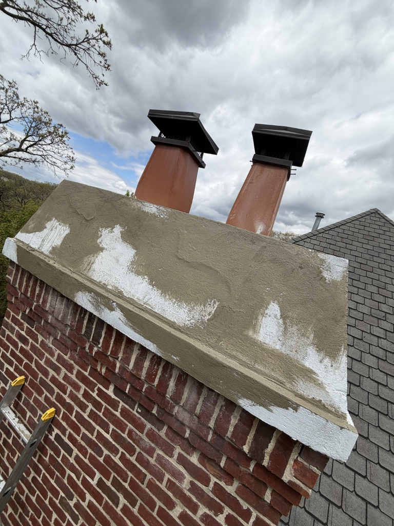 Concrete patching in progress on chimney crown