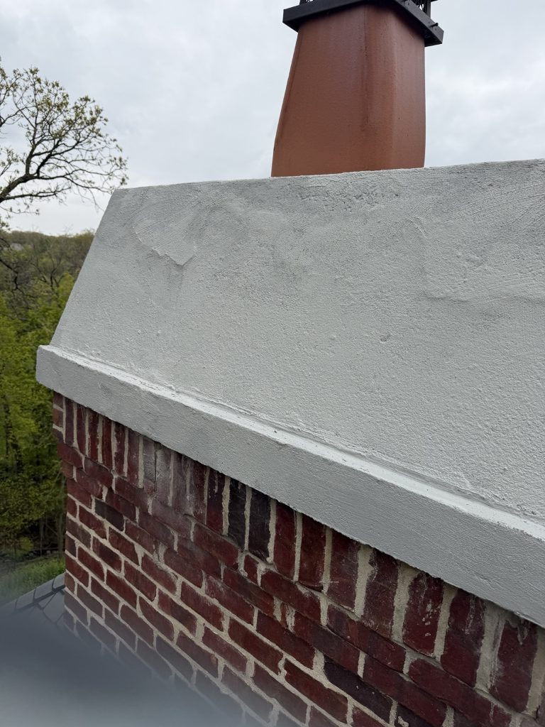 Finished concrete patch repair on chimney crown