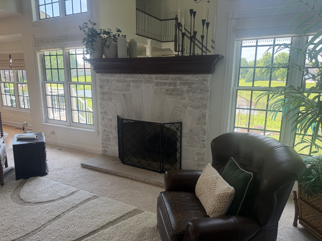 Whitewashed fireplace with natural masonry texture showing