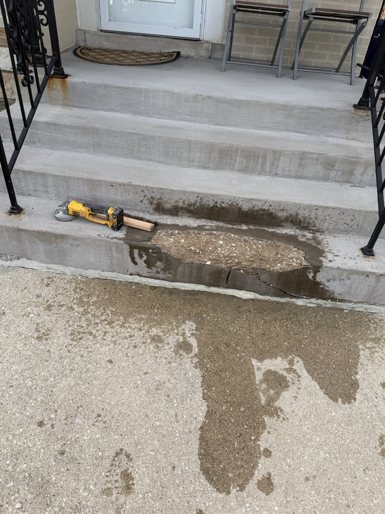 Chipped concrete step prepared for patching