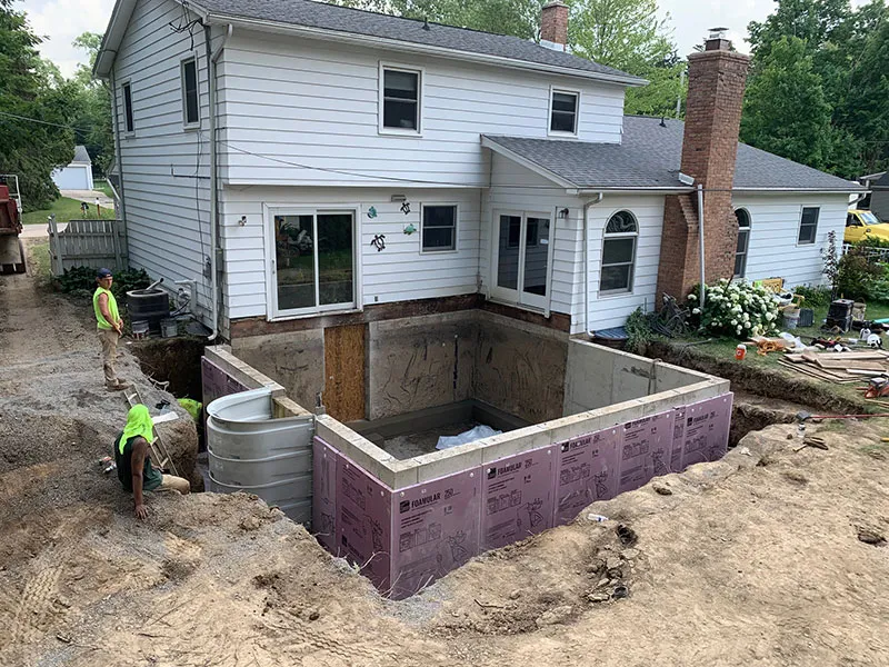 Excavation and concrete foundation work with rigid foam insulation for residential addition