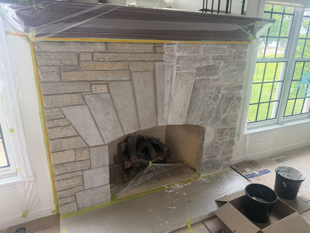 Limewash being applied to interior fireplace masonry