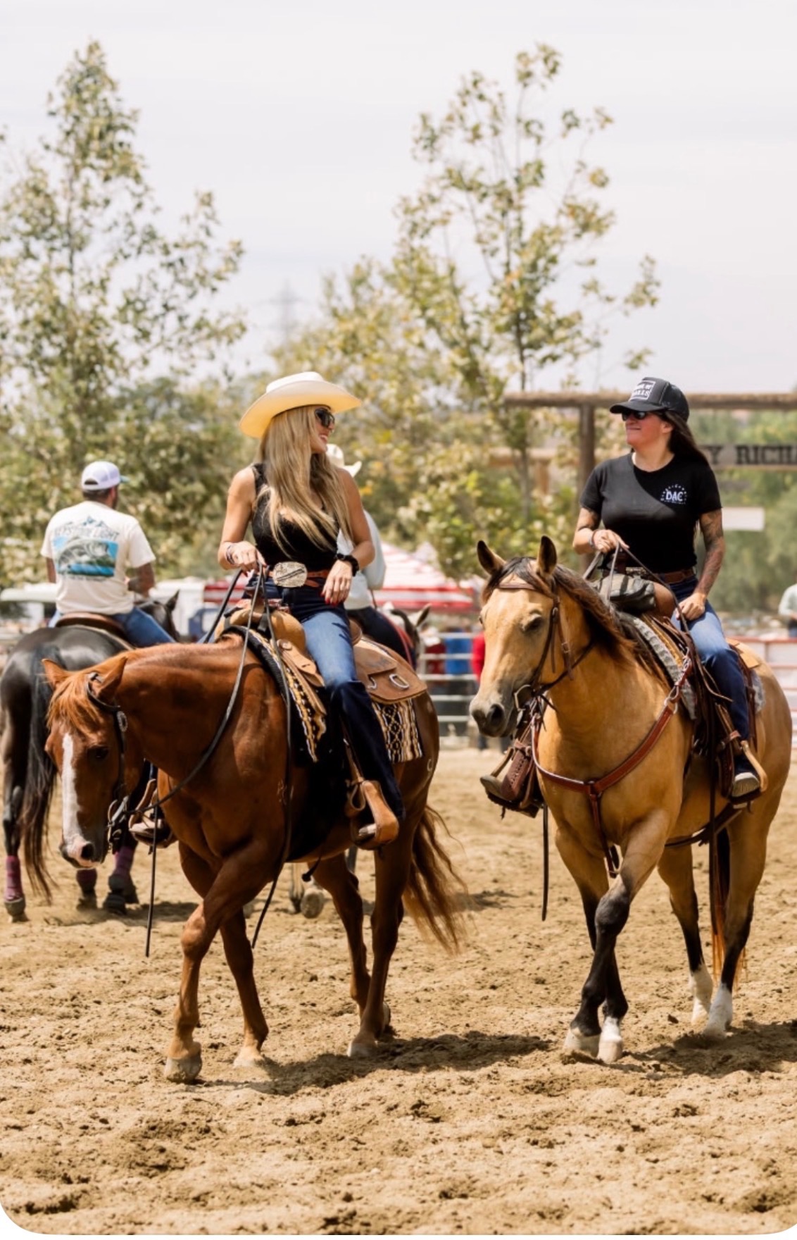Two riders on horseback in an arena