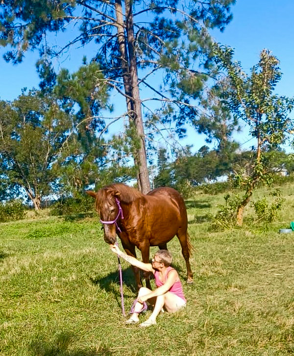 Sheri-Lynne sitting with Stella in the paddock