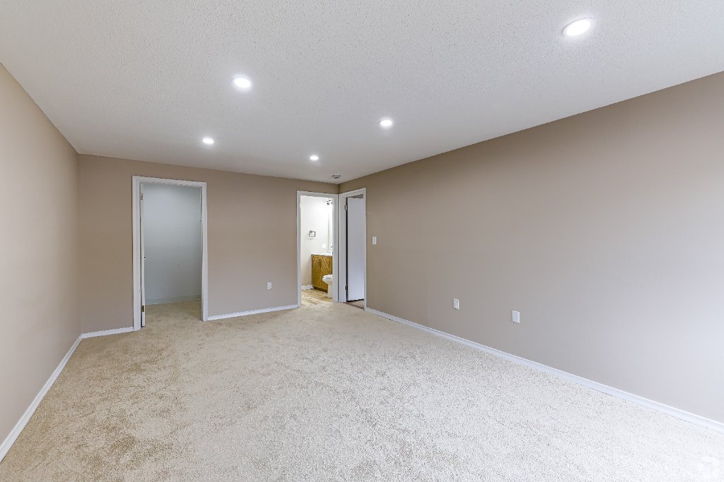 Bedroom with carpet and natural light