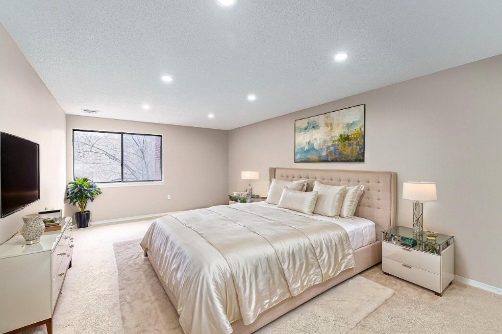 Bedroom with carpet and natural light
