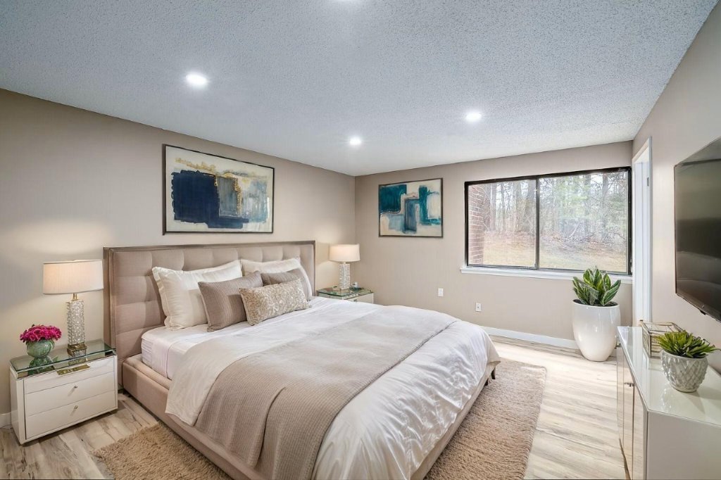 Bedroom with hardwood floors and blue artwork