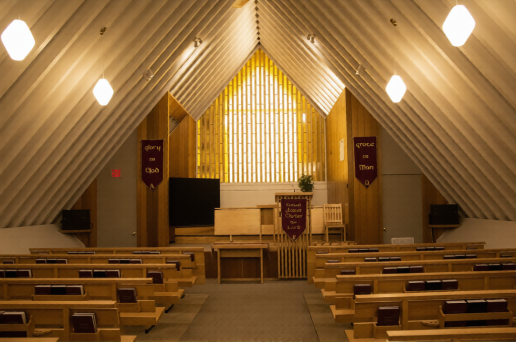 Church interior with golden light streaming through stained glass