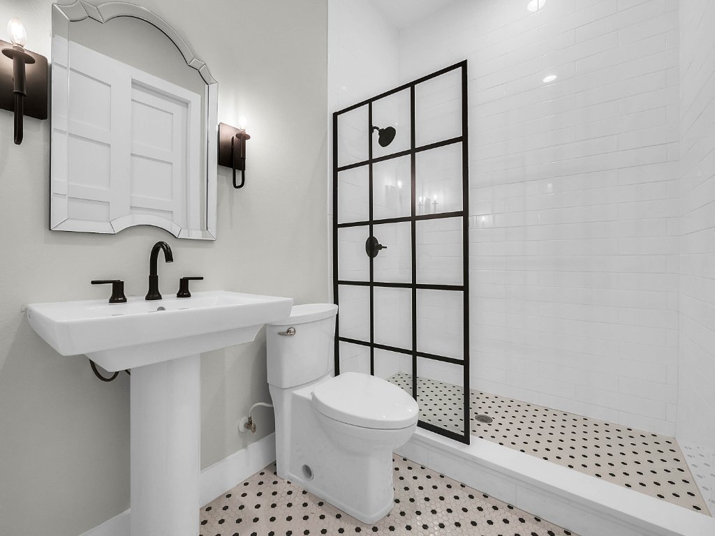 Modern farmhouse new construction with white board-and-batten exterior, metal roof, and front porch in Orlando
