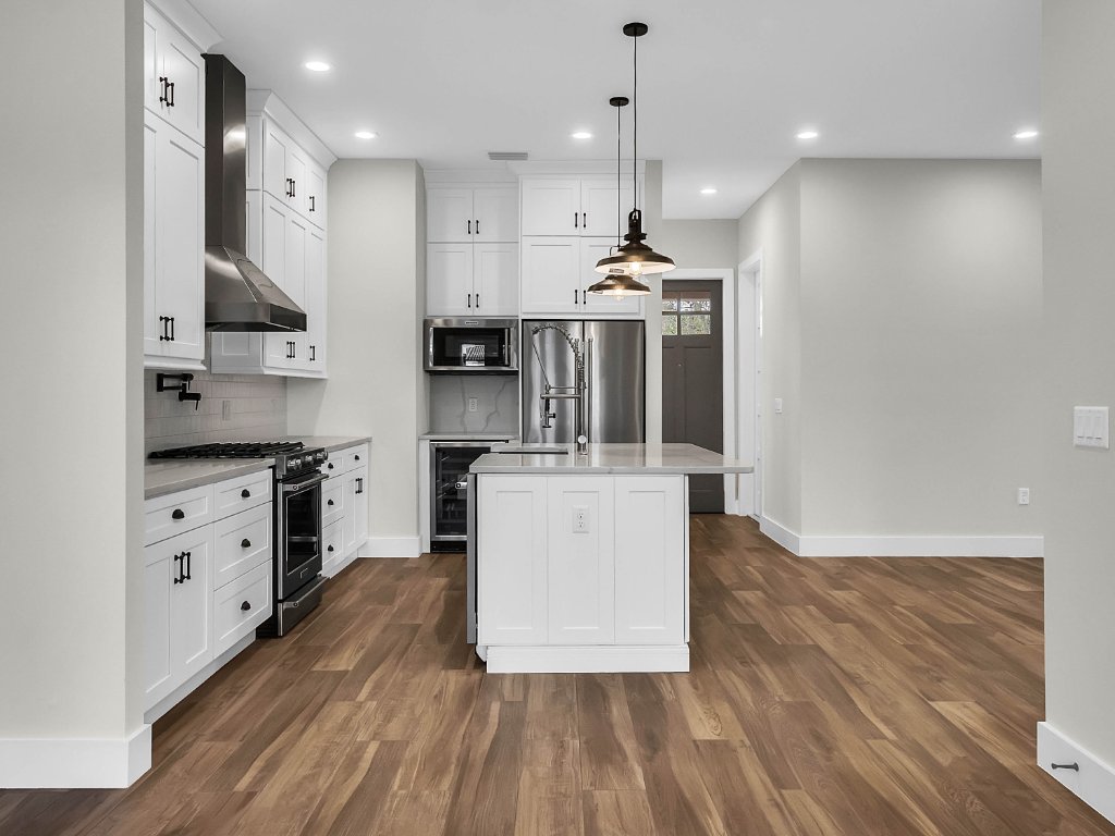 Modern farmhouse new construction with white board-and-batten exterior, metal roof, and front porch in Orlando