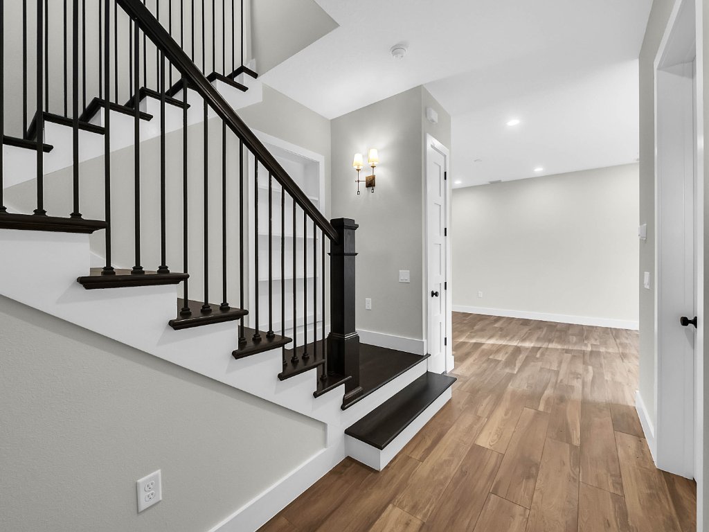 Modern farmhouse new construction with white board-and-batten exterior, metal roof, and front porch in Orlando