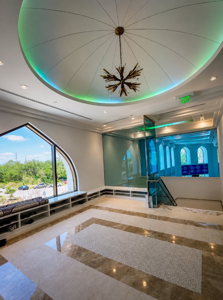 Interior of The Islamic Center of Orlando prayer hall with domed ceiling, gold mihrab, and teal prayer carpet
