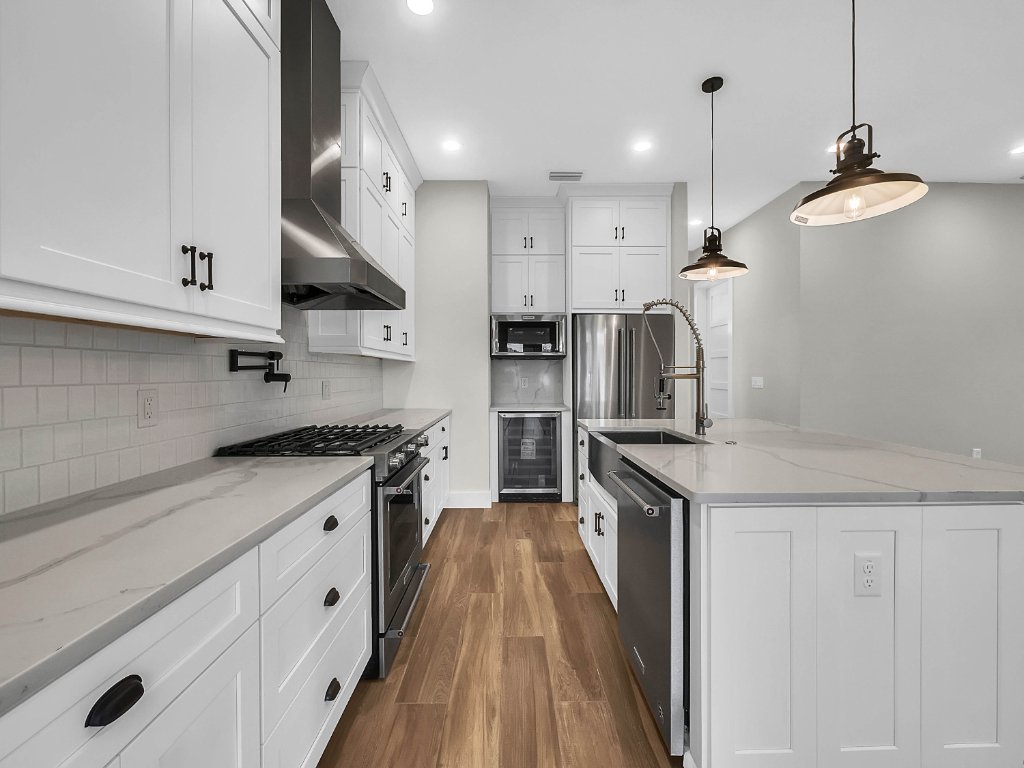 Modern farmhouse new construction with white board-and-batten exterior, metal roof, and front porch in Orlando