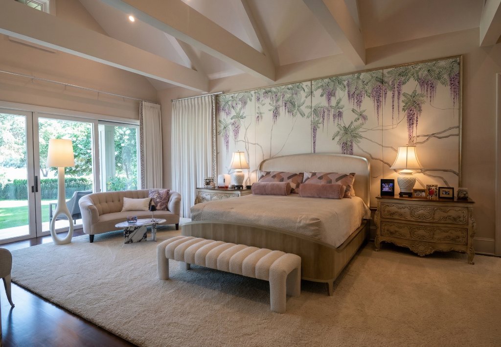 Serene luxury master bedroom with vaulted beamed ceiling, wisteria mural headboard wall, and soft neutral palette in Winter Park