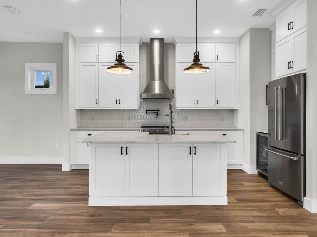 Modern farmhouse new construction with white board-and-batten exterior, metal roof, and front porch in Orlando