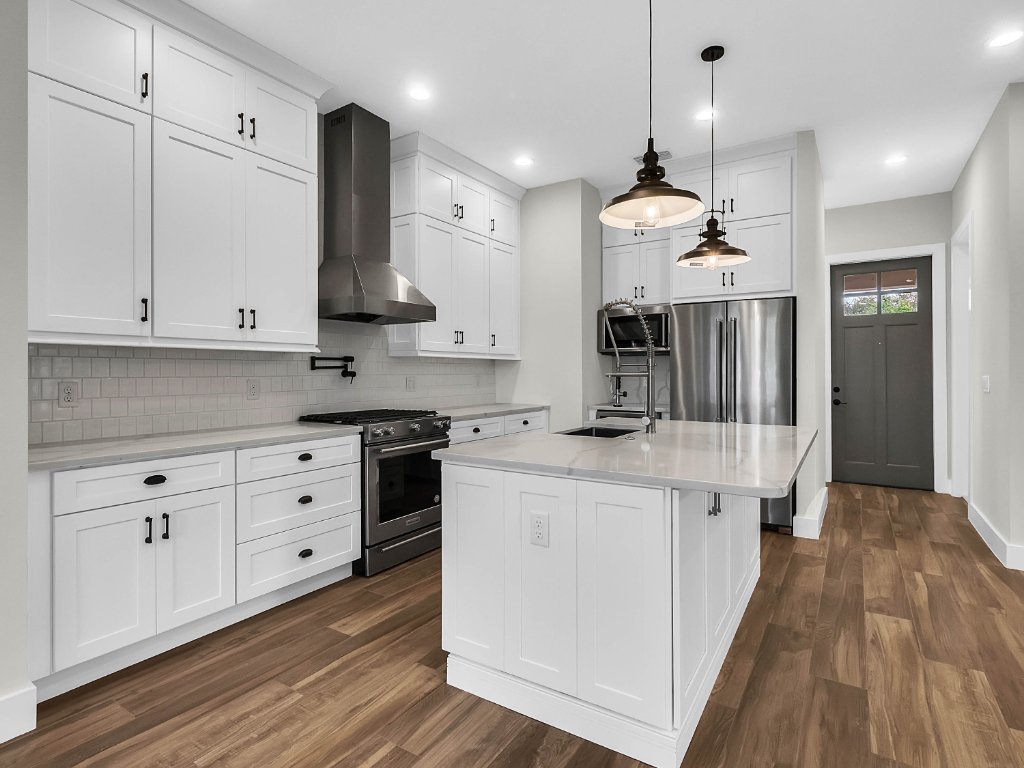 Modern farmhouse new construction with white board-and-batten exterior, metal roof, and front porch in Orlando