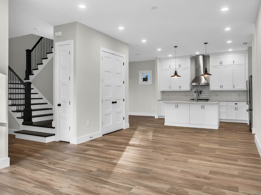 Modern farmhouse new construction with white board-and-batten exterior, metal roof, and front porch in Orlando