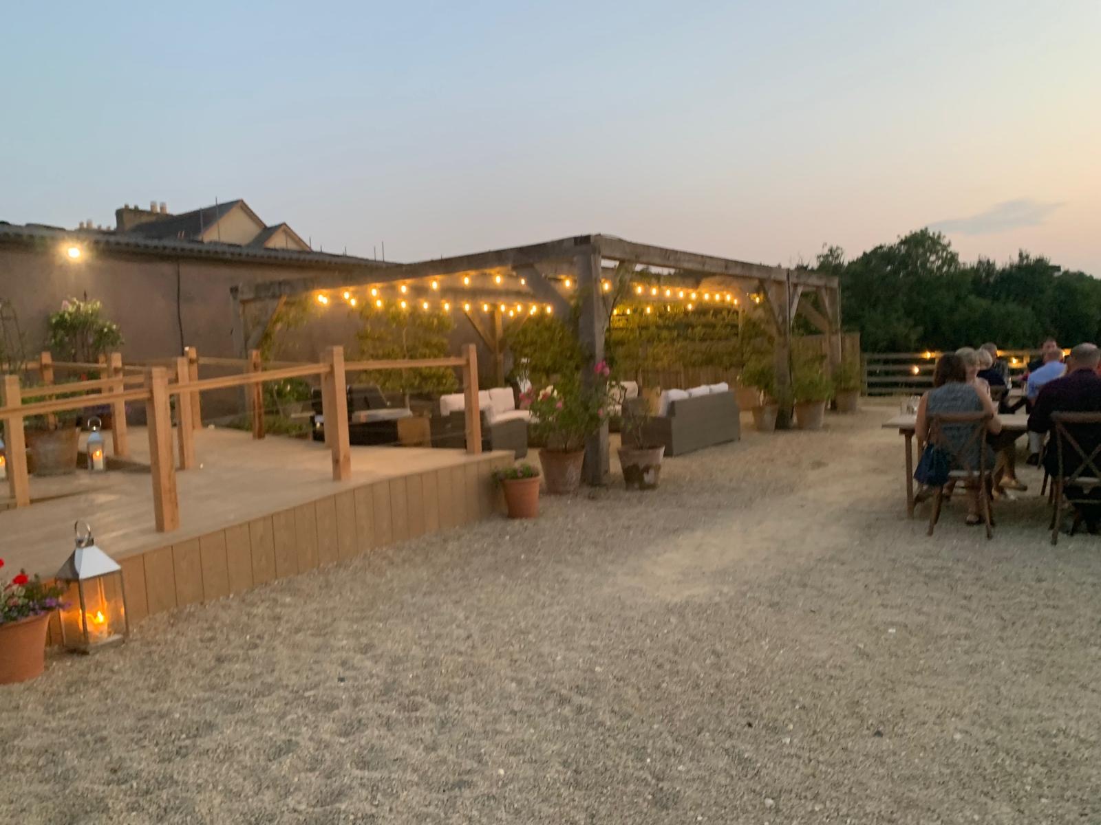Festoon lighting to pergola and outdoor seating area