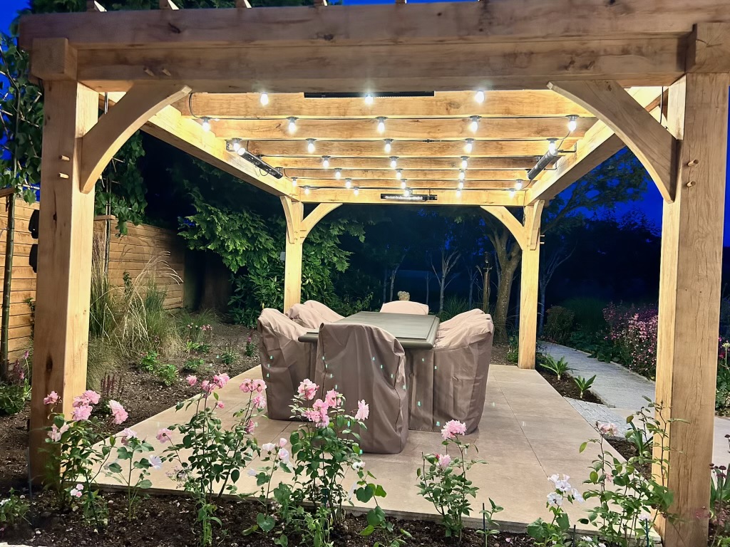 Oak pergola with Edison string lighting and infrared heaters