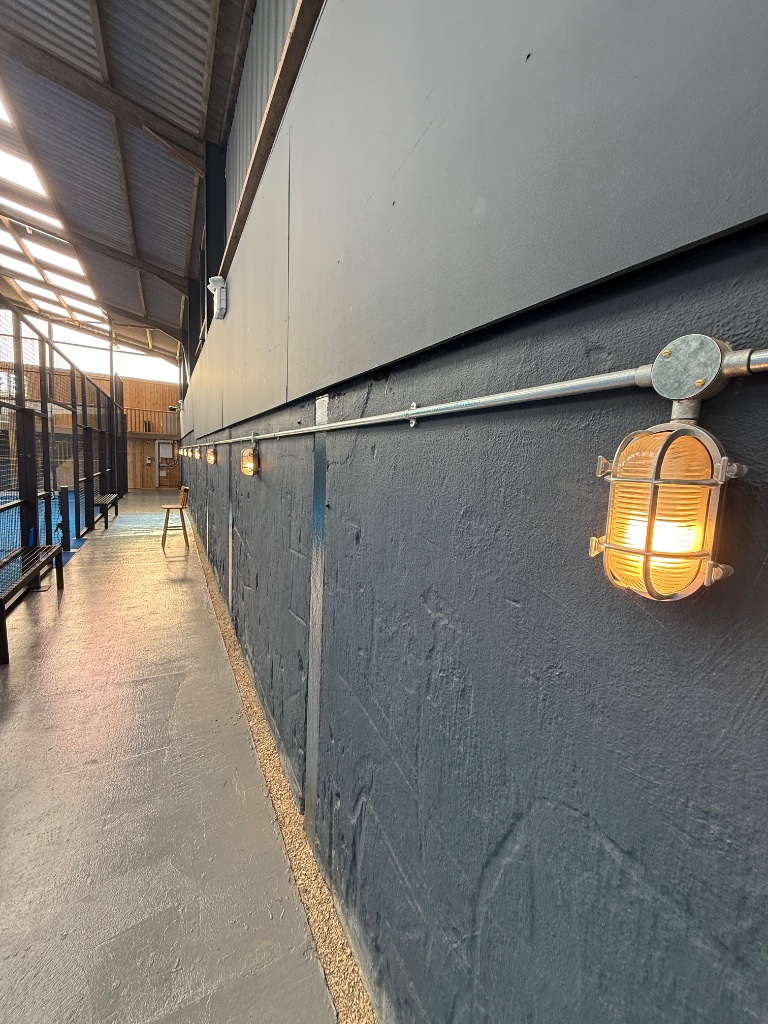 Courtside corridor - galvanised conduit and feature bulkhead lighting