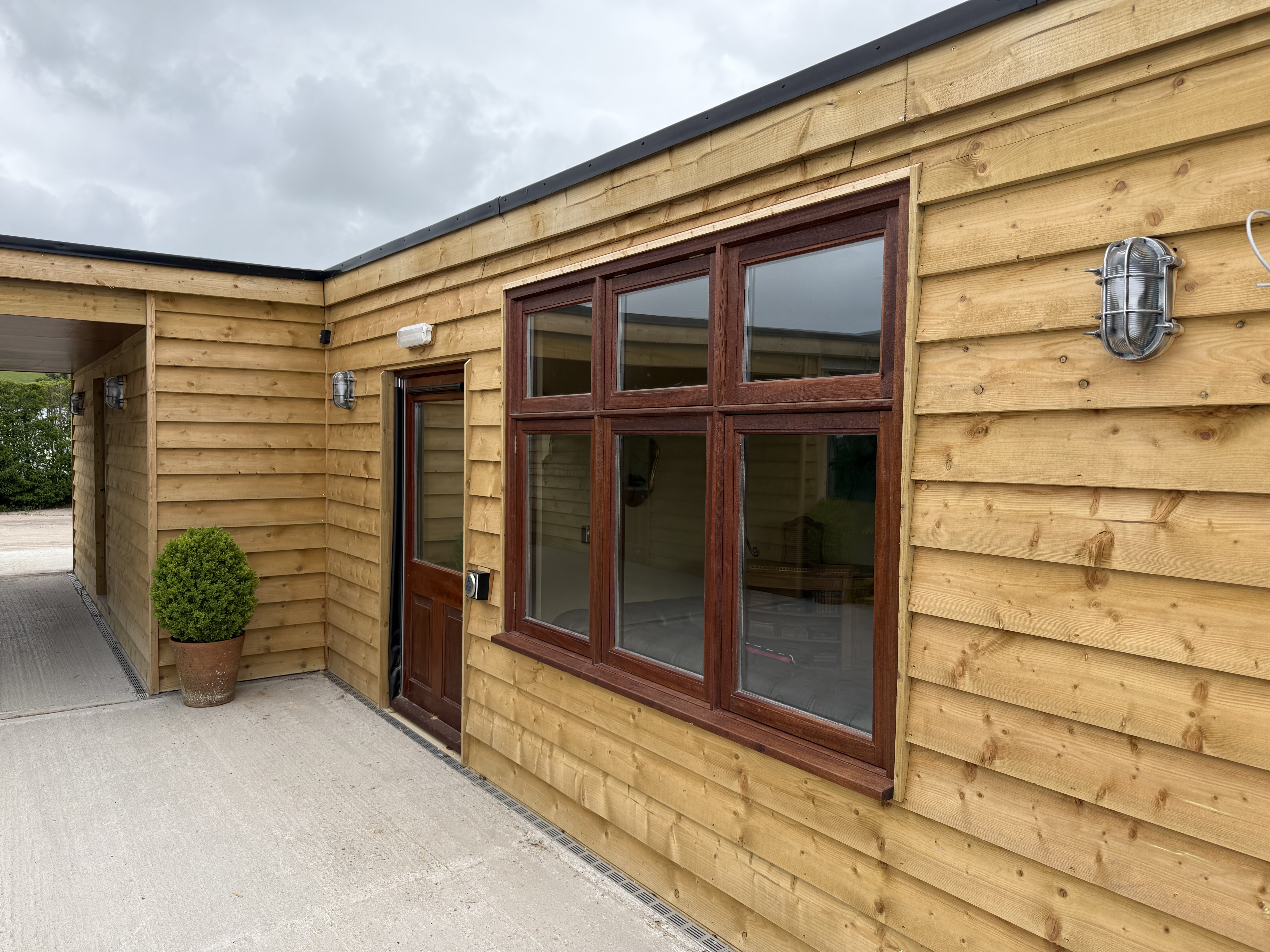 Exterior bulkhead lighting and dark-framed glazing