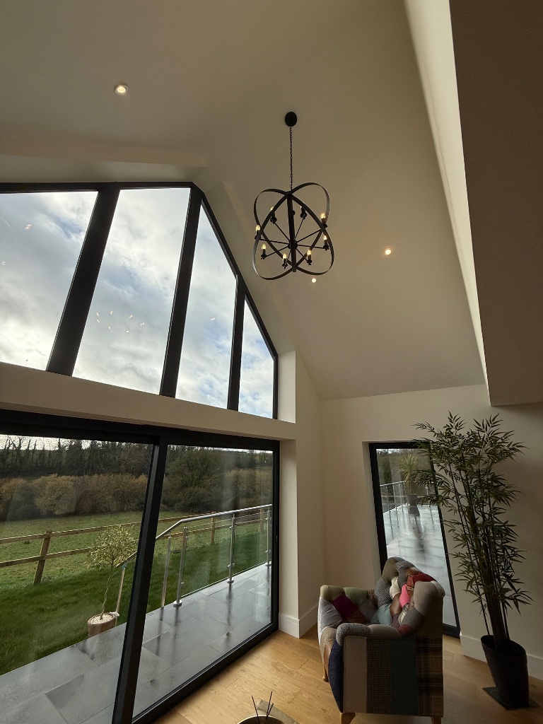 Double-height entrance hall - feature chandelier and recessed downlights