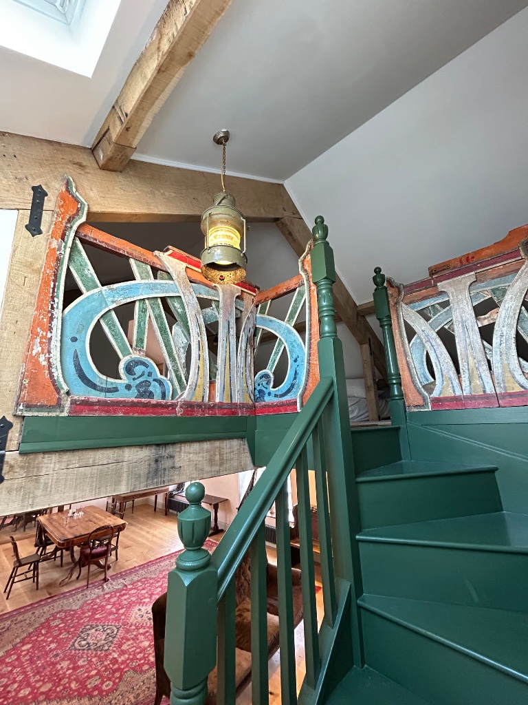 Mezzanine staircase - antique ship's lantern and fairground balustrade