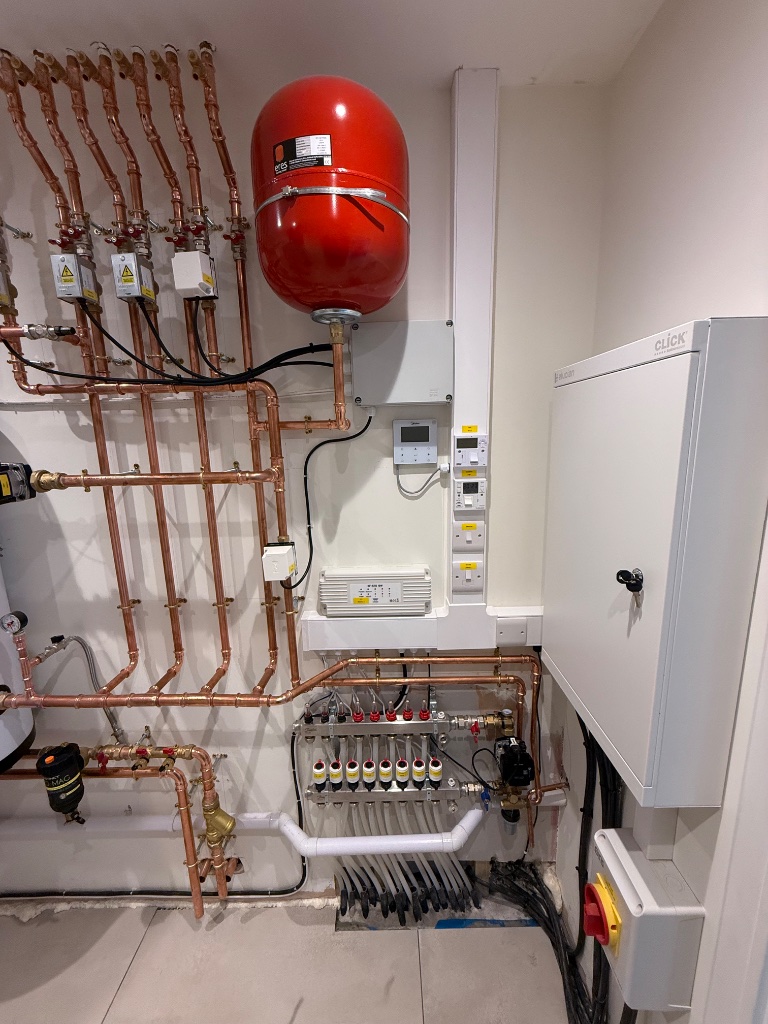 Plant room - underfloor heating manifolds, distribution board and controls