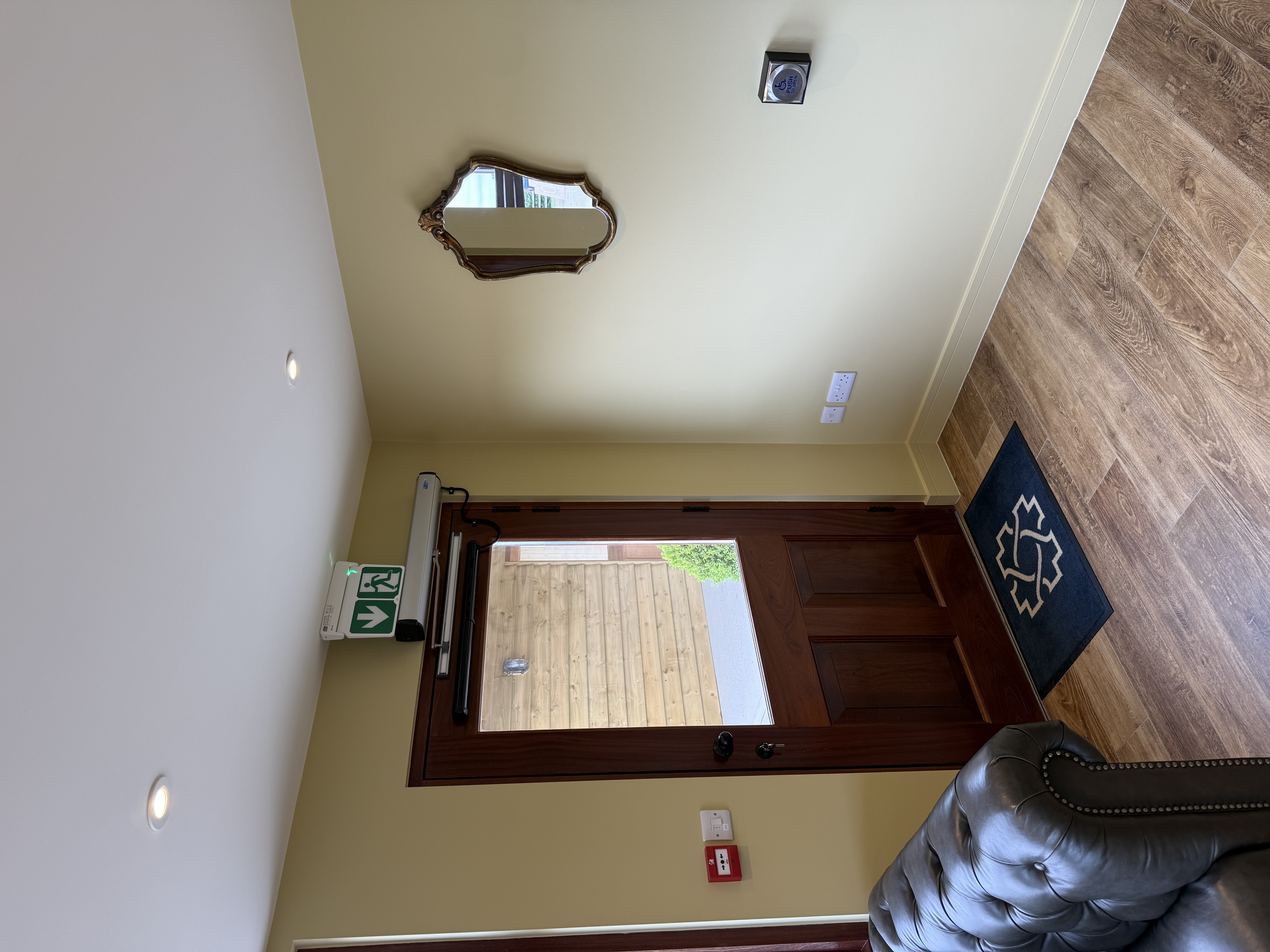 Disabled access controls, fire alarm call point and emergency exit signage