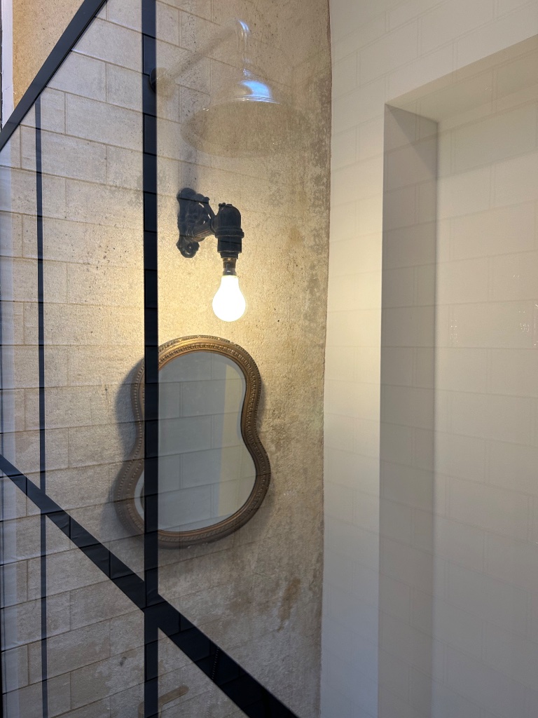 Shower room - antique wall light with glass dome shade
