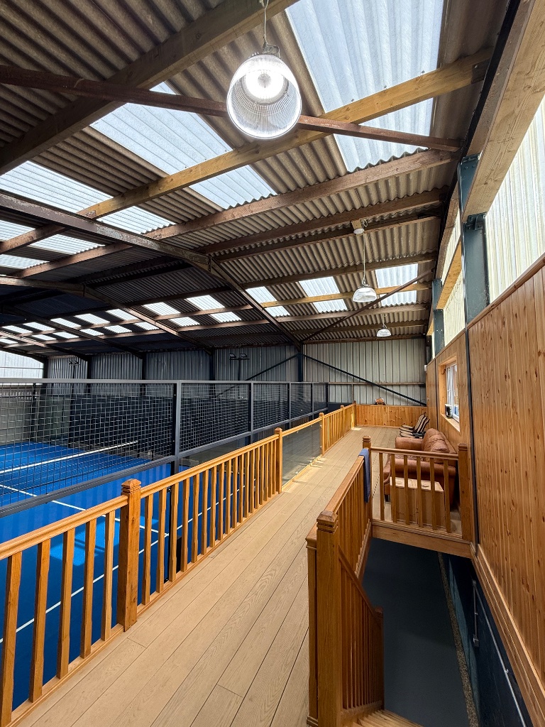 Mezzanine spectator gallery - high bay lighting and timber balustrade