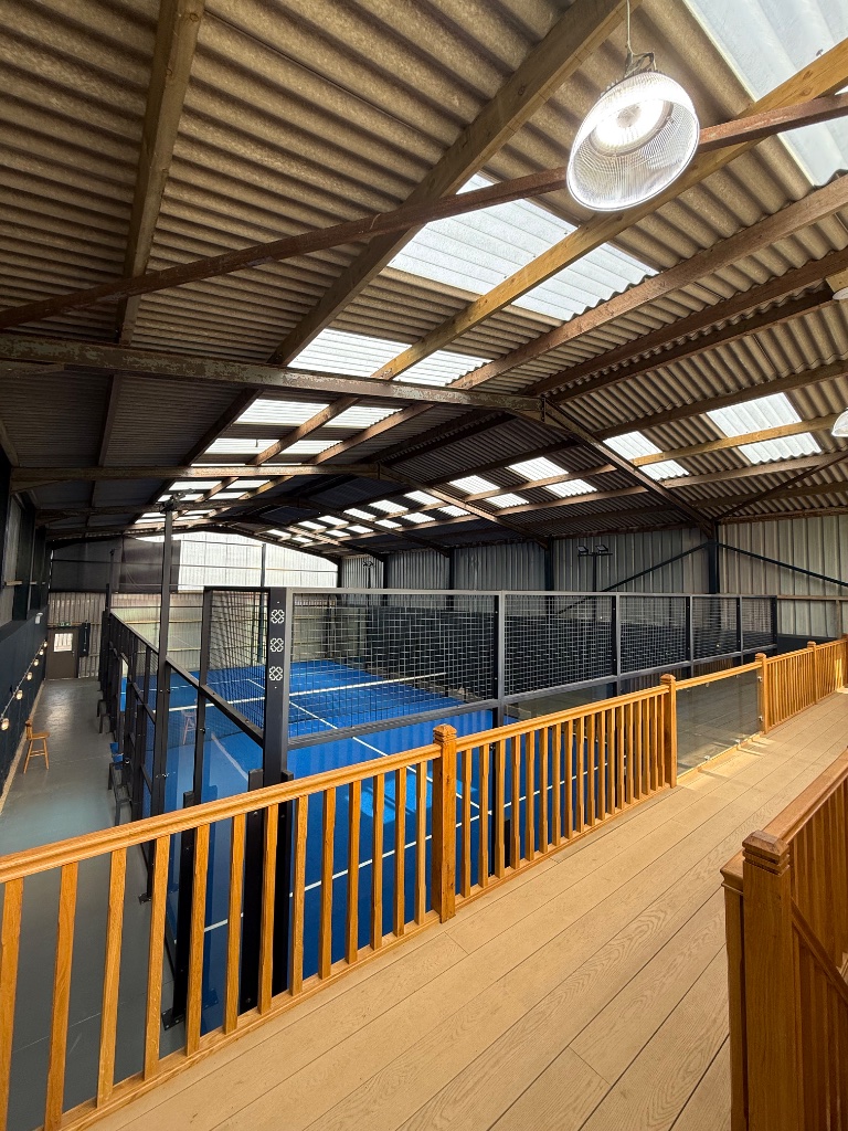 Court viewed from mezzanine - high bay lighting over the blue playing surface