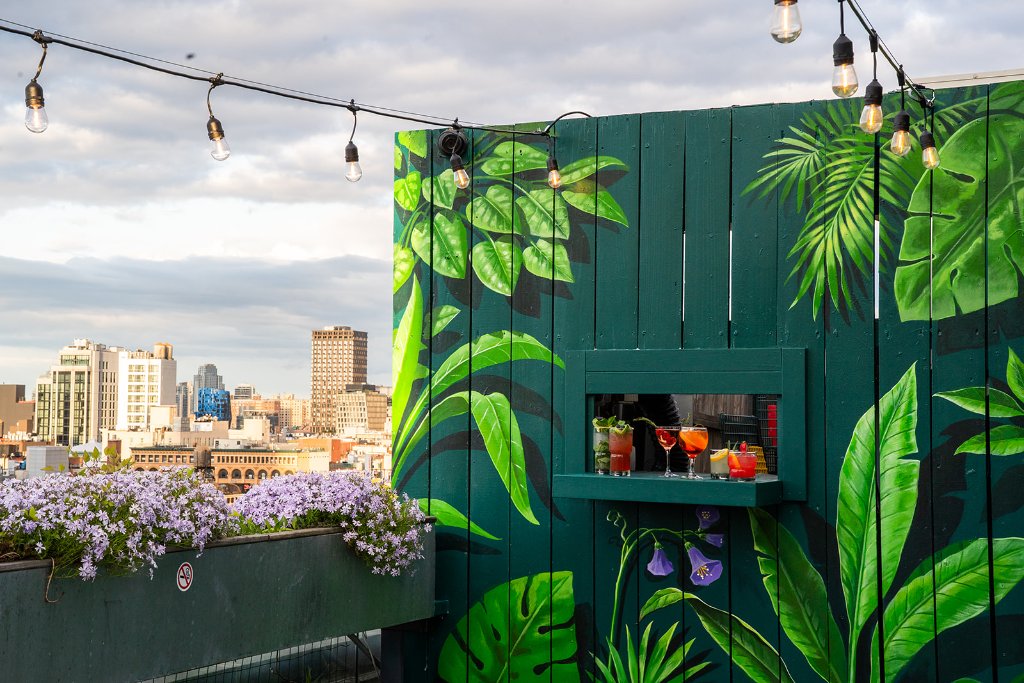 Mural bar cocktails NYC skyline Walker Rooftop