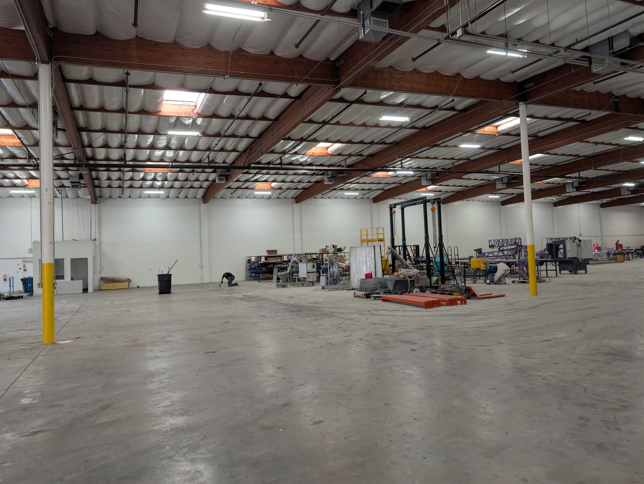 Spacious industrial warehouse interior cleared out by Get It All Out junk removal service