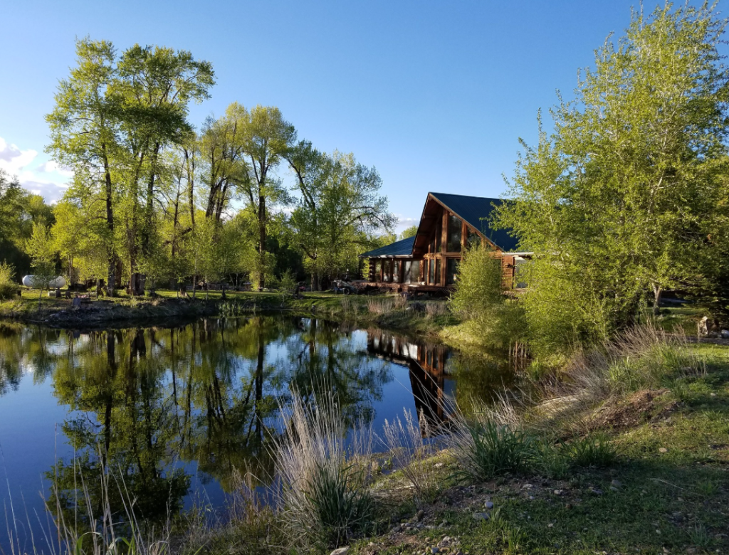 Spirit West lodge reflected in river