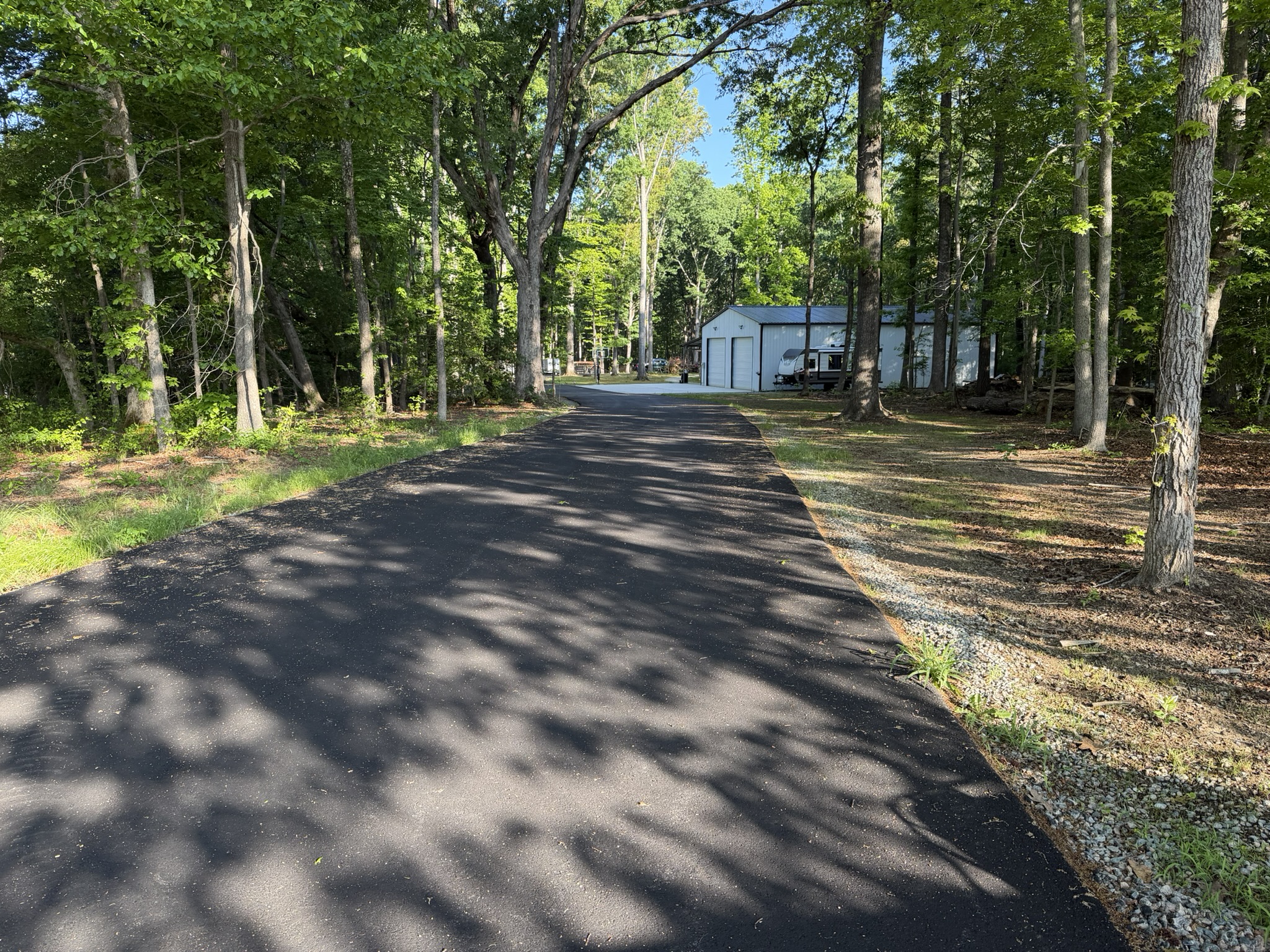Tree-lined driveway leading to the Powhatan facility