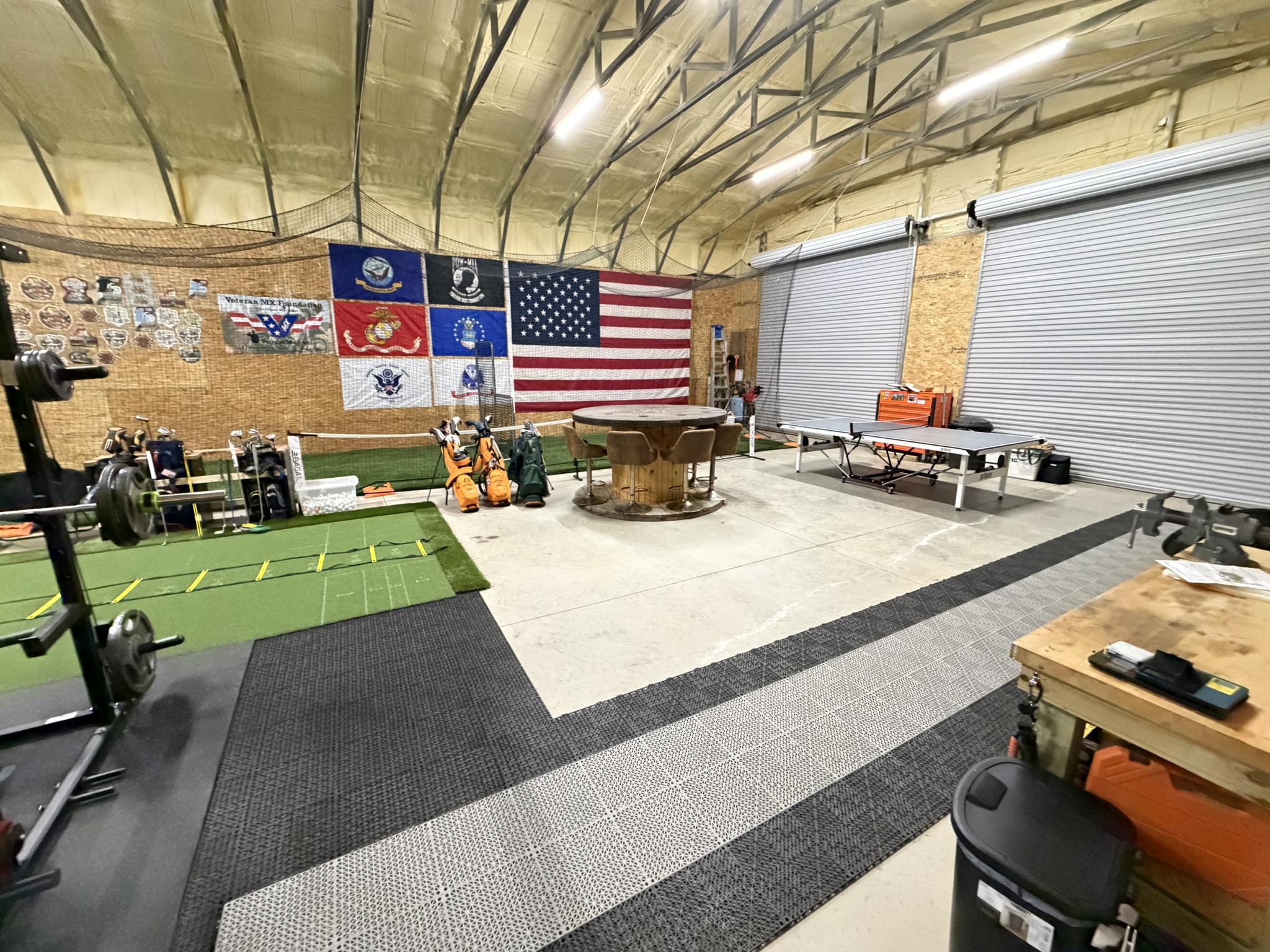 Training floor with turf area, seating, and ping-pong table