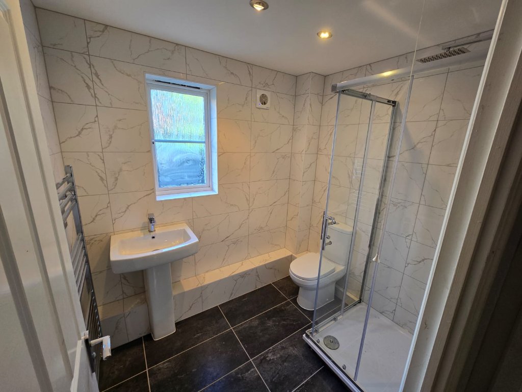 Marble Tiled Bathroom with Heated Towel Rail
