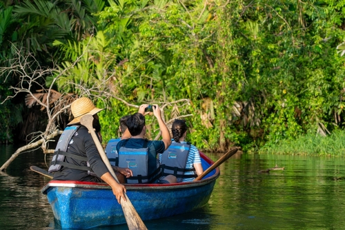 Family boat tour through Costa Rica jungle river