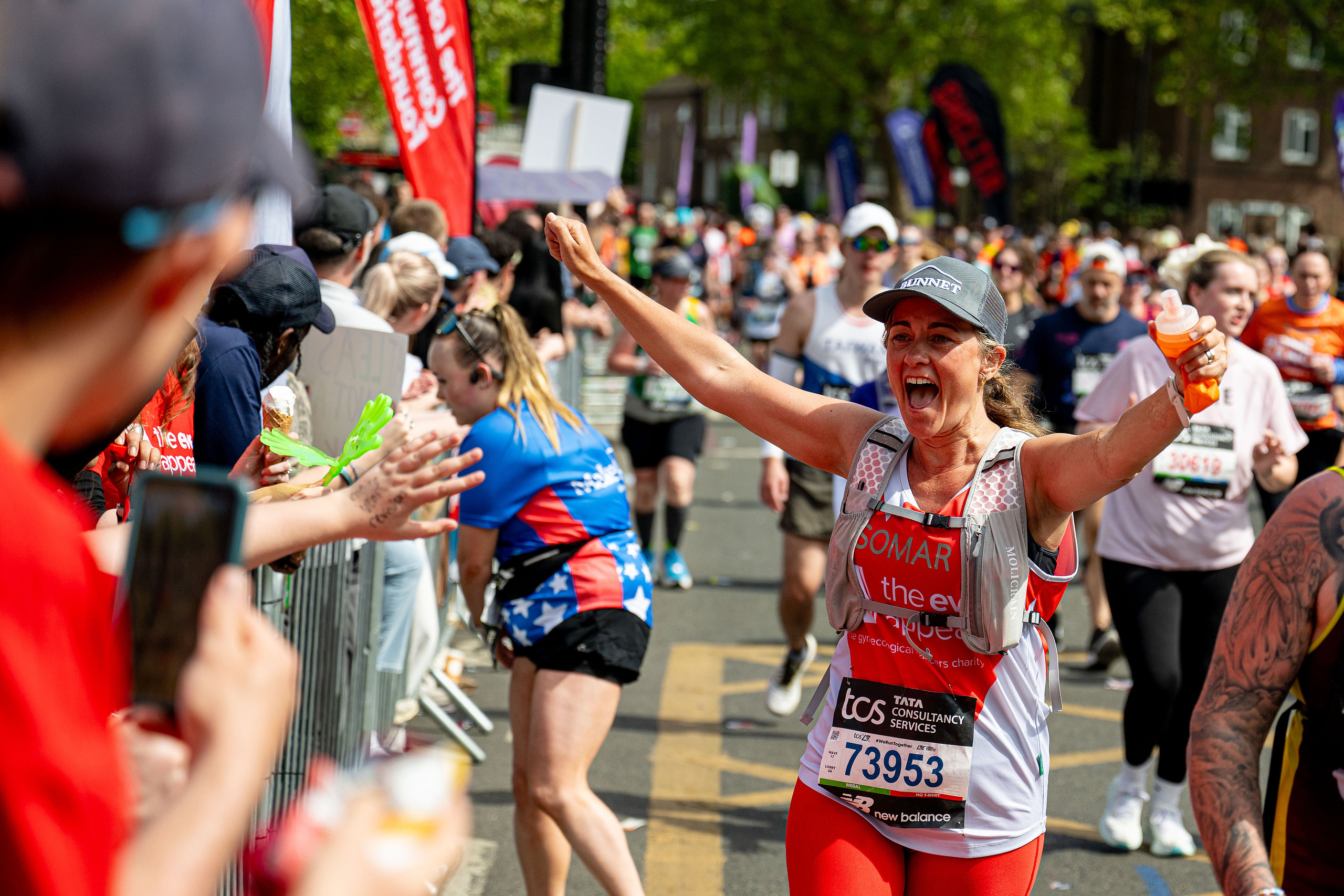 Somar, founder of DrawFunder, celebrating while running the London Marathon