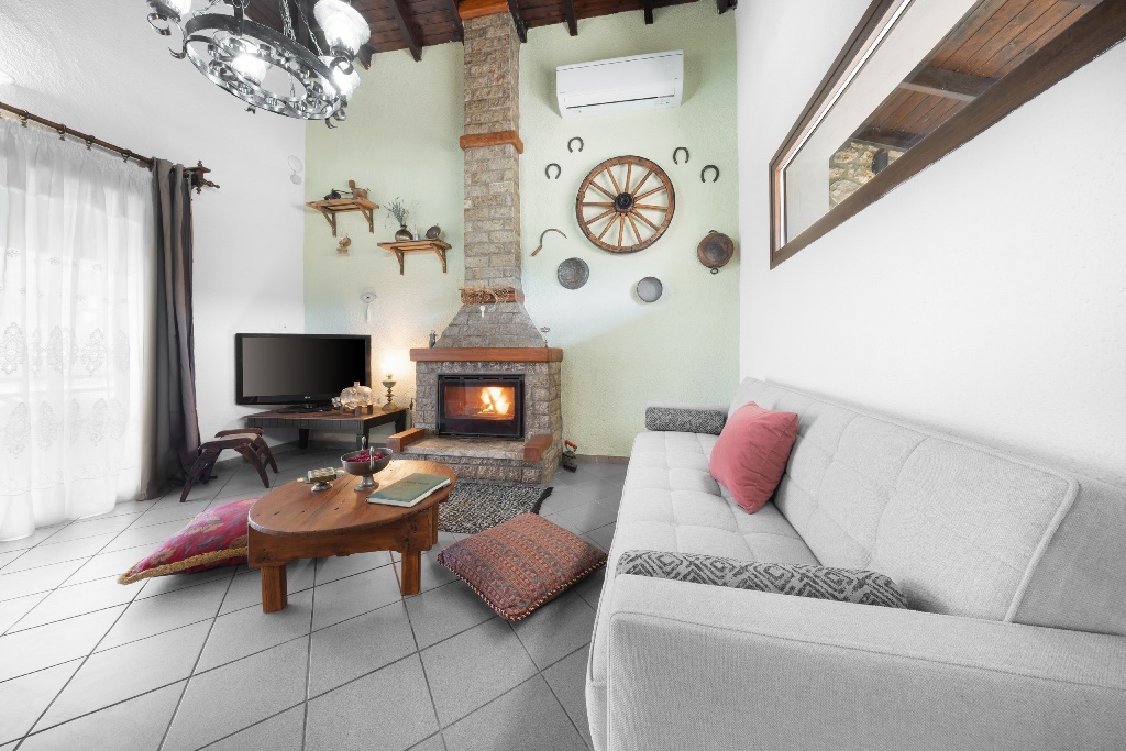 Stone fireplace with burning fire at Chalet Renata 1