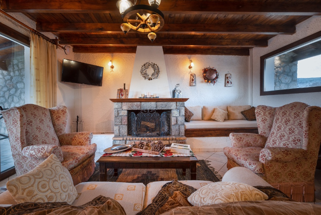 Cosy living room with stone fireplace at Chalet Renata