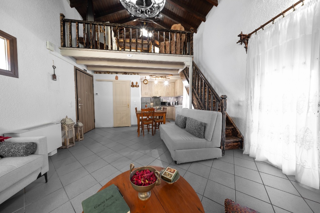 Open-plan living area with loft overlooking the space at Chalet Renata 1